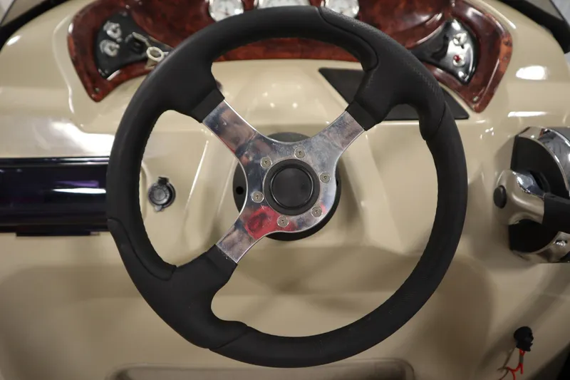 Slide: The Image of Steering wheel of 2014 Sun Tracker Party Barge 24 DLX boat, featuring control panel. - 18