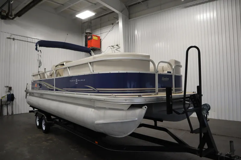 Slide: The Image of 2014 Sun Tracker Party Barge 24 DLX pontoon boat in indoor storage. - 2