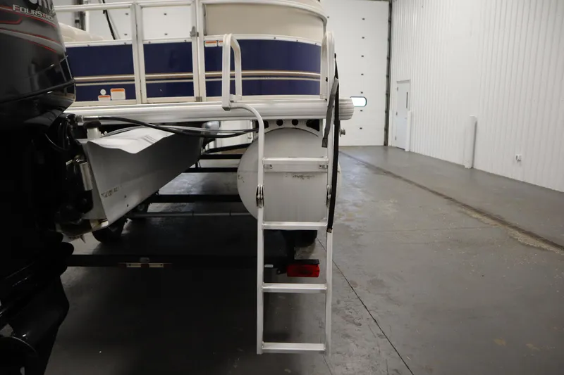 Slide: The Image of 2014 Sun Tracker Party Barge 24 DLX pontoon boat with ladder in indoor storage. - 29