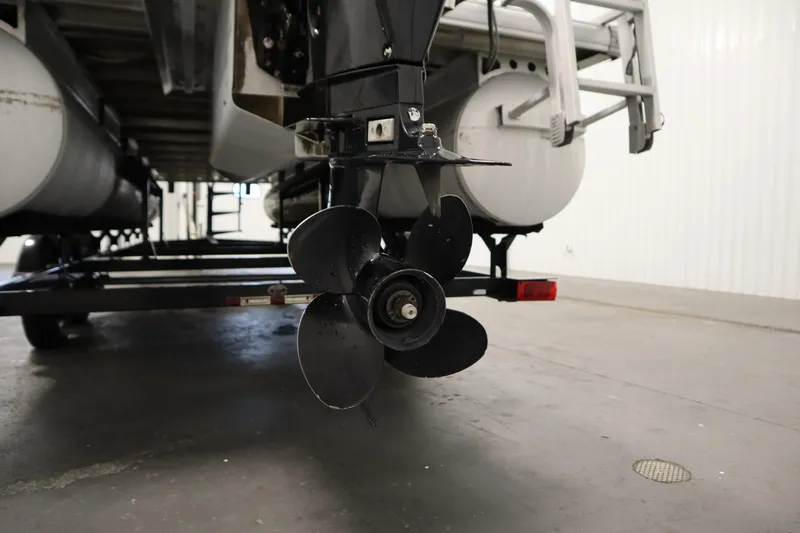 Slide: The Image of 2014 Sun Tracker Party Barge 24 DLX pontoon boat propeller in a garage. - 34