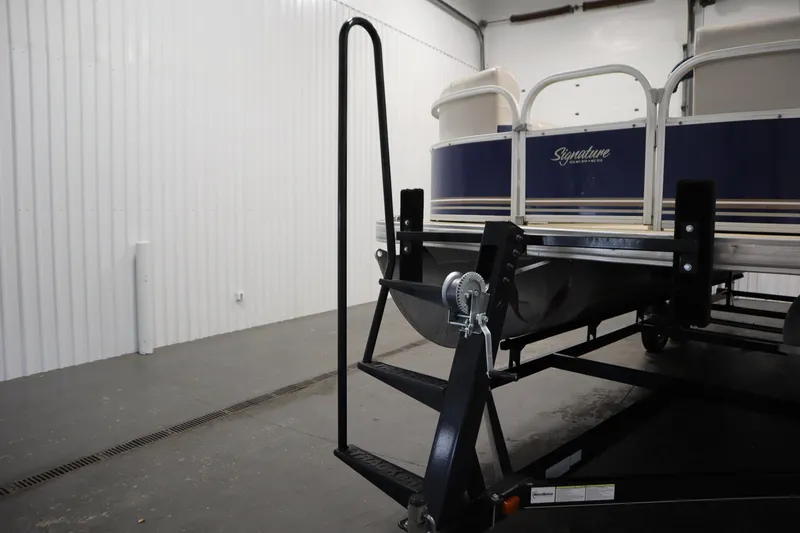 Slide: The Image of 2014 Sun Tracker Party Barge 24 DLX on trailer in storage facility. - 36