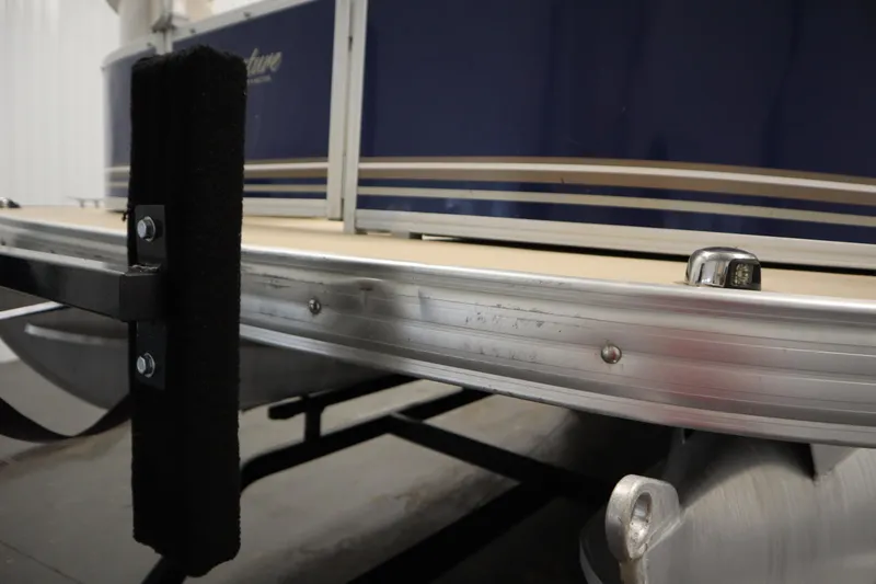 Slide: The Image of 2014 Sun Tracker Party Barge 24 DLX pontoon boat detail with blue exterior and metal trim. - 40