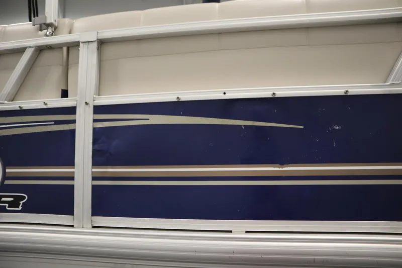Slide: The Image of 2014 Sun Tracker Party Barge 24 DLX pontoon boat side panel with blue and beige design. - 43