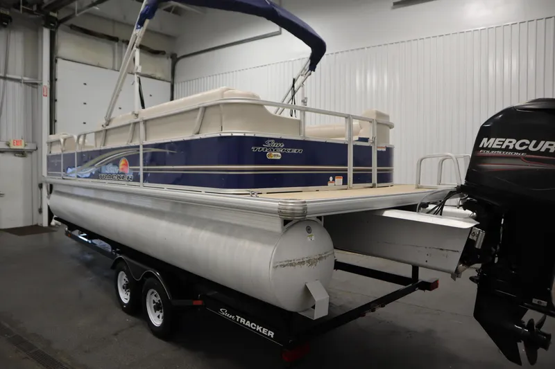 Slide: The Image of 2014 Sun Tracker Party Barge 24 DLX pontoon boat with Mercury outboard motor in a garage. - 6