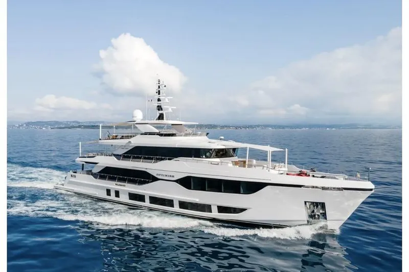 Slide: The Image of Luxurious 2023 Majesty 120 yacht cruising on open sea under clear skies. - 0