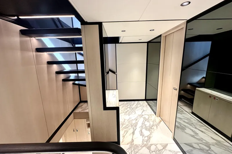 Slide: The Image of Modern interior of 2023 Majesty 120 yacht with sleek staircase and marble flooring. - 16