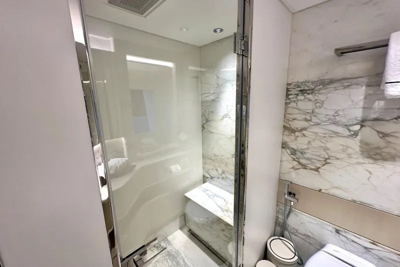 Slide: The Image of Luxurious marble bathroom in 2023 Majesty 120 yacht, featuring modern shower and elegant design. - 19