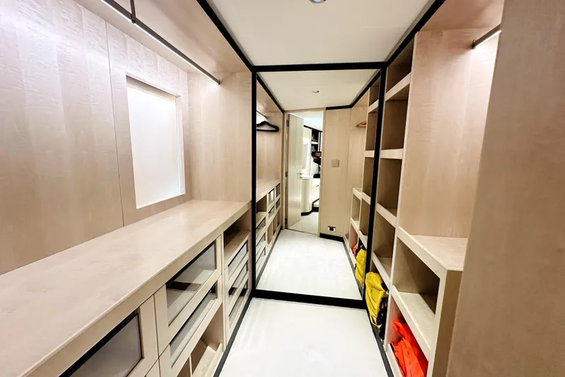 Slide: The Image of Luxurious walk-in closet on 2023 Majesty 120 yacht, featuring ample shelving and modern design. - 23