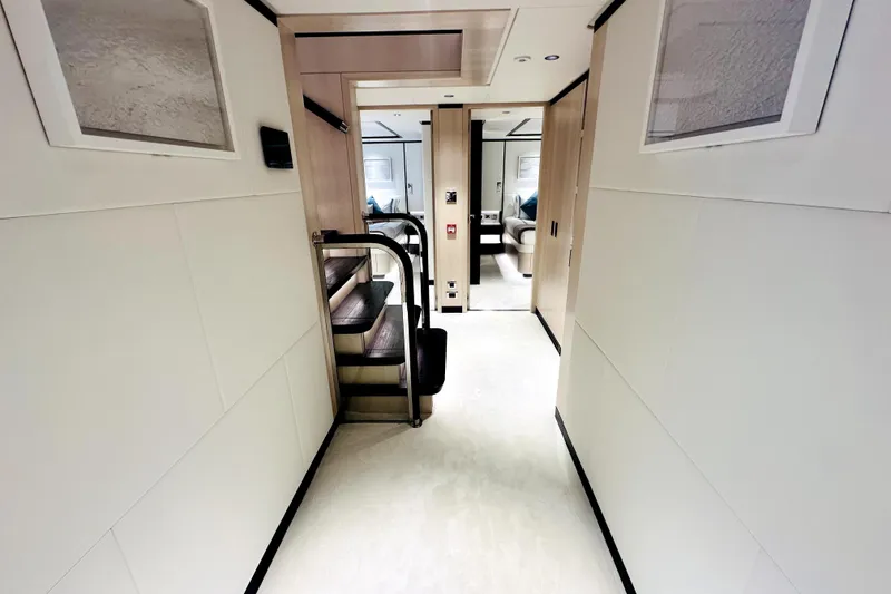 Slide: The Image of Luxurious interior hallway of 2023 Majesty 120 yacht with modern design and staircase. - 37