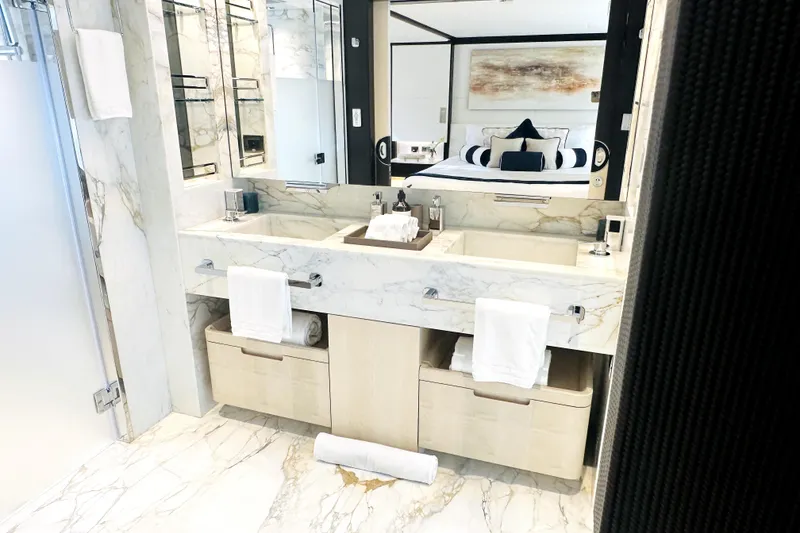 Slide: The Image of Luxurious marble bathroom in 2023 Majesty 120 yacht, featuring dual sinks and elegant decor. - 41