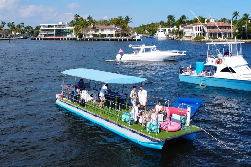 The Image of 2023 Maurell Pontoon boat with passengers enjoying a sunny day on the water. - 1