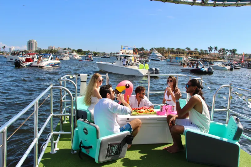 Slide: The Image of Group enjoying on 2023 Maurell PONTOON boat, surrounded by water and other boats. - 3