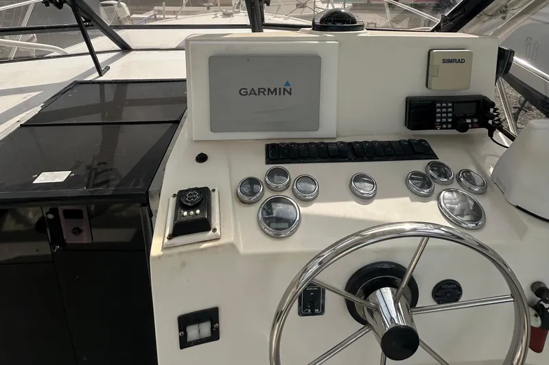 Slide: The Image of Control panel of a 1995 Carolina Classic 28 boat with Garmin and Simrad equipment. - 1