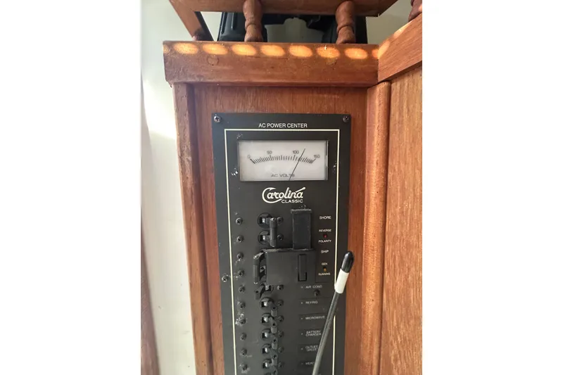 Slide: The Image of 1995 Carolina Classic 28 AC power center with wooden paneling and control switches. - 11