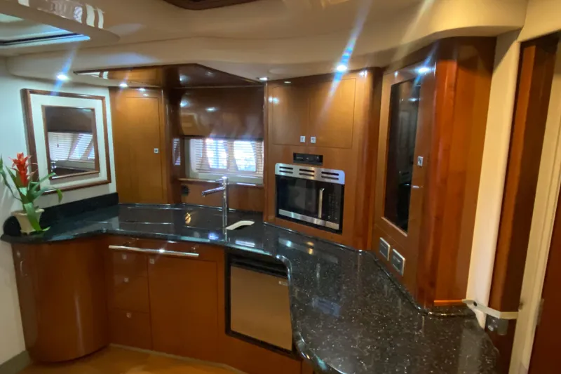 Slide: The Image of Luxurious 2008 Sea Ray 44 Sundancer yacht interior with modern kitchen and sleek wood finishes. - 11