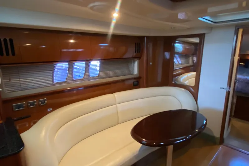 Slide: The Image of Interior of 2008 Sea Ray 44 Sundancer yacht with elegant seating and wooden table. - 12