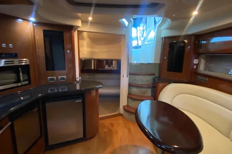 Slide: The Image of Luxurious interior of 2008 Sea Ray 44 Sundancer yacht with modern kitchen and seating area. - 14