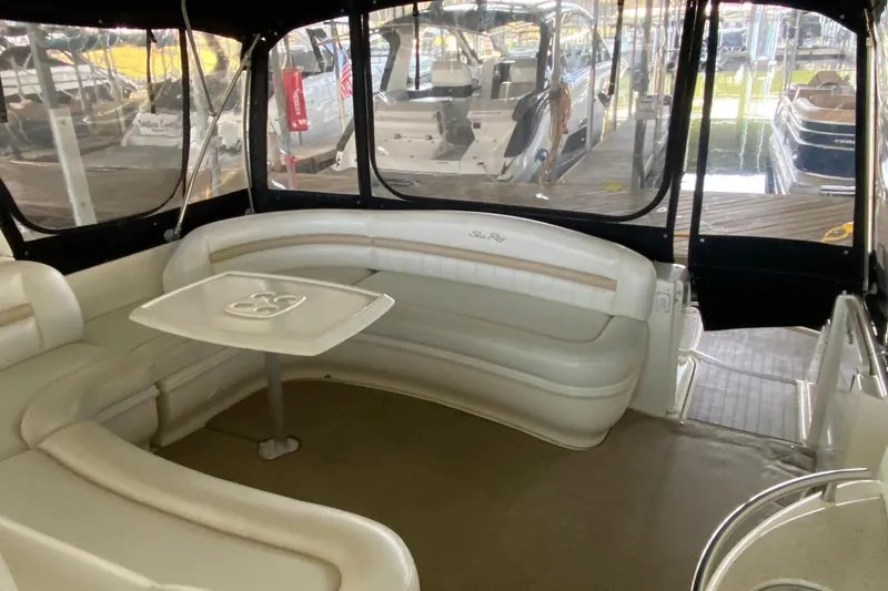Slide: The Image of 2008 Sea Ray 44 Sundancer yacht interior with curved seating and table in a marina setting. - 6