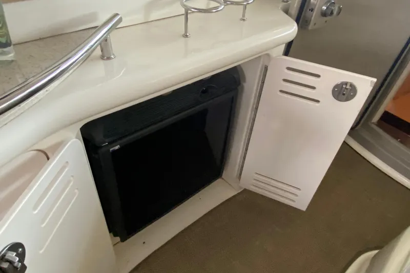 Slide: The Image of Open cabinet on 2008 Sea Ray 44 Sundancer yacht, revealing interior storage space. - 9