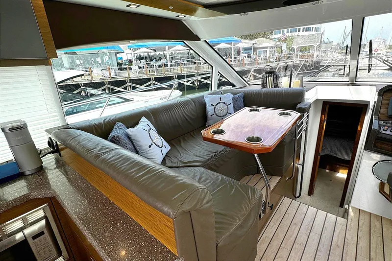Slide: The Image of Luxurious 2014 Cruisers Yachts 45 Cantius interior with plush seating and elegant table. - 13