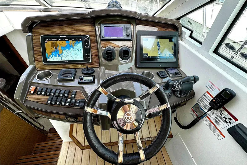 Slide: The Image of Helm of 2014 Cruisers Yachts 45 Cantius with navigation screens and controls. - 14