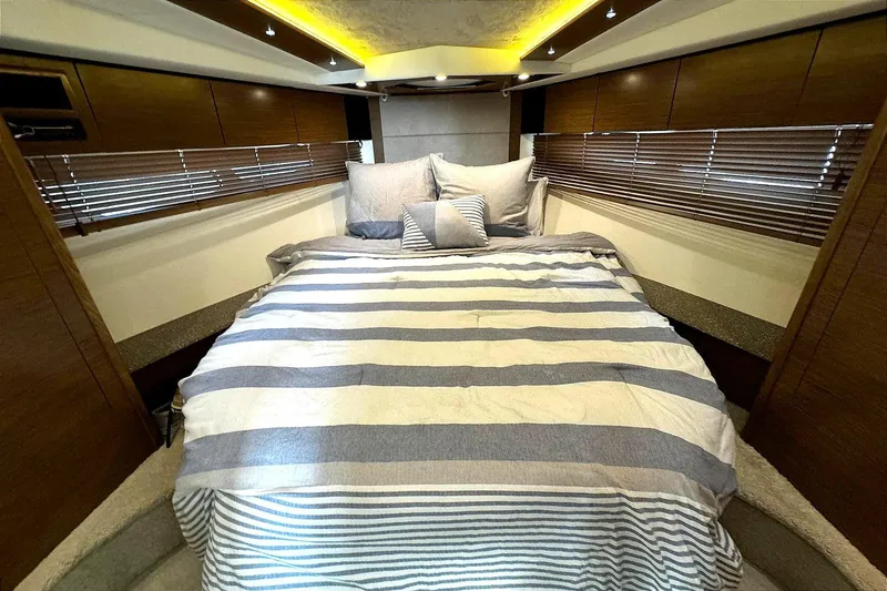 Slide: The Image of Luxurious bedroom interior of 2014 Cruisers Yachts 45 Cantius with striped bedding. - 16