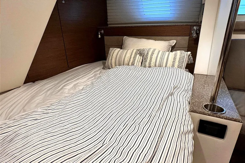 Slide: The Image of Luxurious bedroom interior of 2014 Cruisers Yachts 45 Cantius with striped bedding. - 18