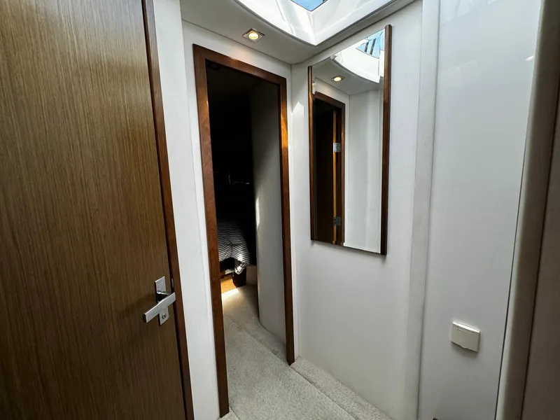 Slide: The Image of Hallway inside 2014 Cruisers Yachts 45 Cantius, featuring wooden doors and a wall mirror. - 21