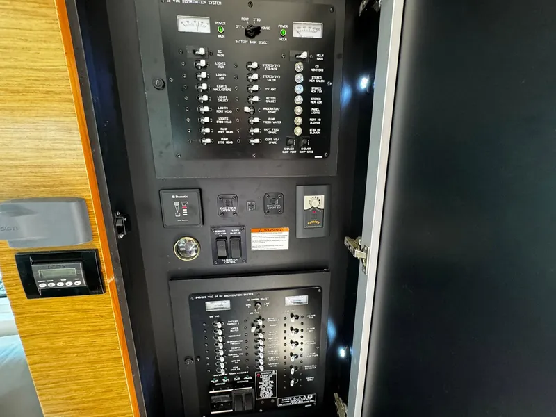 Slide: The Image of Electrical control panel inside 2014 Cruisers Yachts 45 Cantius, featuring switches and indicators. - 22