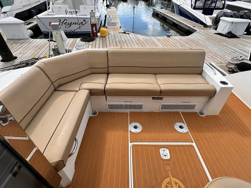Slide: The Image of 2014 Cruisers Yachts 45 Cantius, beige seating, teak deck, docked at marina. - 5