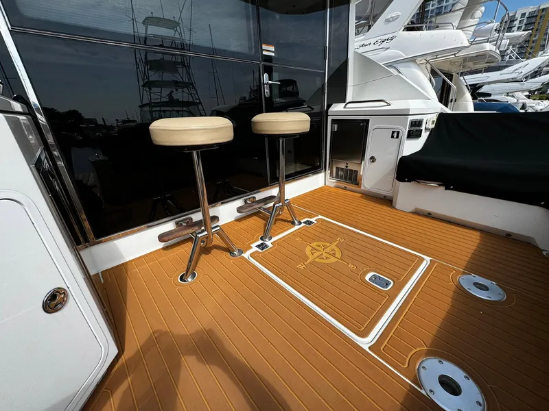 Slide: The Image of 2014 Cruisers Yachts 45 Cantius deck with bar stools and teak flooring. - 9