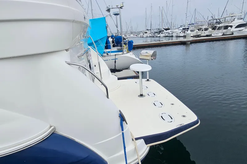 Slide: The Image of 2005 Sea Ray 390 Motor Yacht docked in a marina, surrounded by other boats. - 13