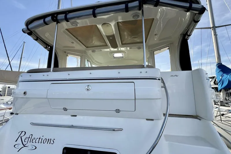 Slide: The Image of 2005 Sea Ray 390 Motor Yacht, rear view, docked with "Reflections" name visible. - 14