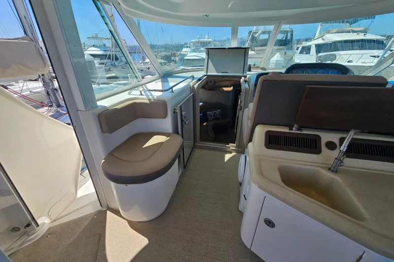 Slide: The Image of 2005 Sea Ray 390 Motor Yacht interior with seating, sink, and marina view. - 16