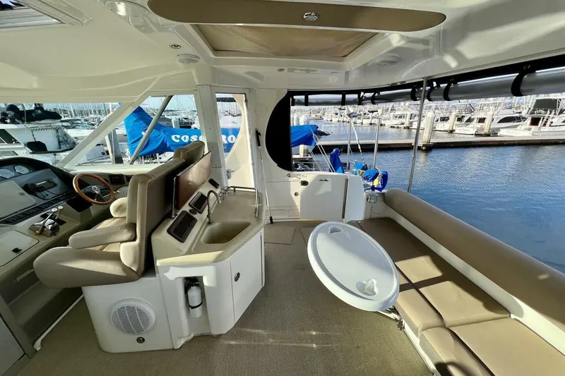 Slide: The Image of 2005 Sea Ray 390 Motor Yacht interior with helm, seating, and marina view. - 18