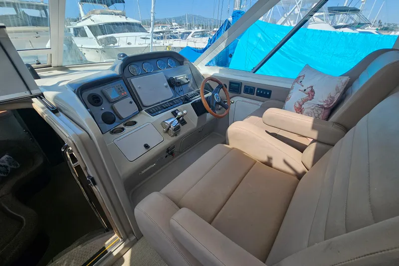 Slide: The Image of 2005 Sea Ray 390 Motor Yacht helm with beige seating and nautical decor. - 21