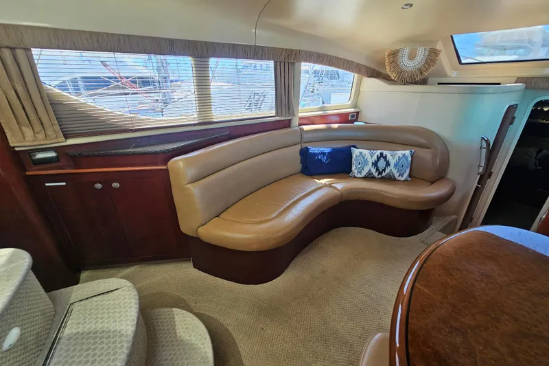 Slide: The Image of Luxurious interior of 2005 Sea Ray 390 Motor Yacht with curved seating and decorative pillows. - 28