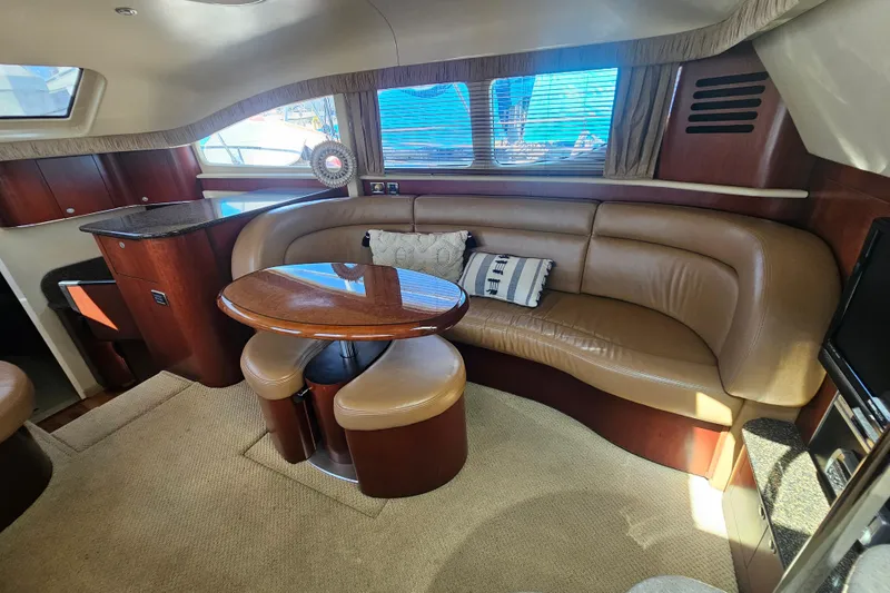 Slide: The Image of Luxurious interior of 2005 Sea Ray 390 Motor Yacht with leather seating and wooden table. - 29