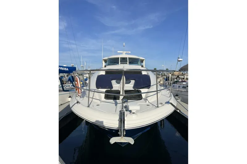 Slide: The Image of 2005 Sea Ray 390 Motor Yacht docked at marina under clear blue sky. - 3