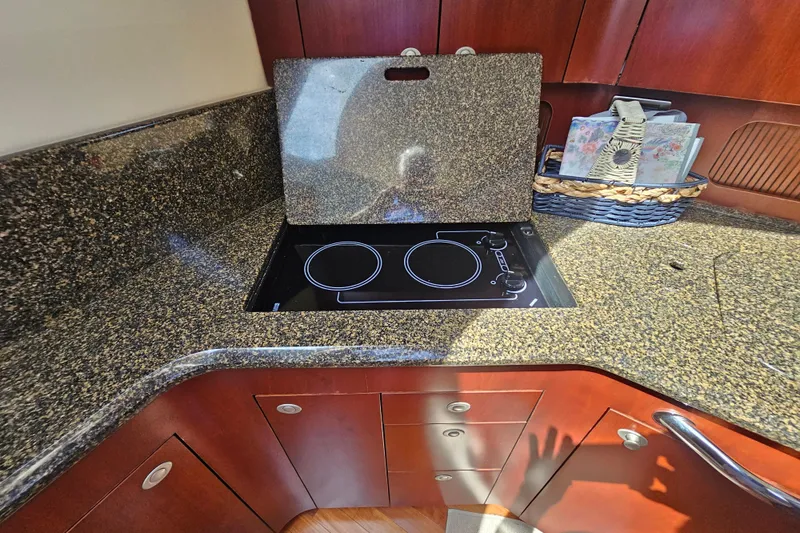 Slide: The Image of 2005 Sea Ray 390 Motor Yacht kitchen with granite countertop and electric stove. - 32