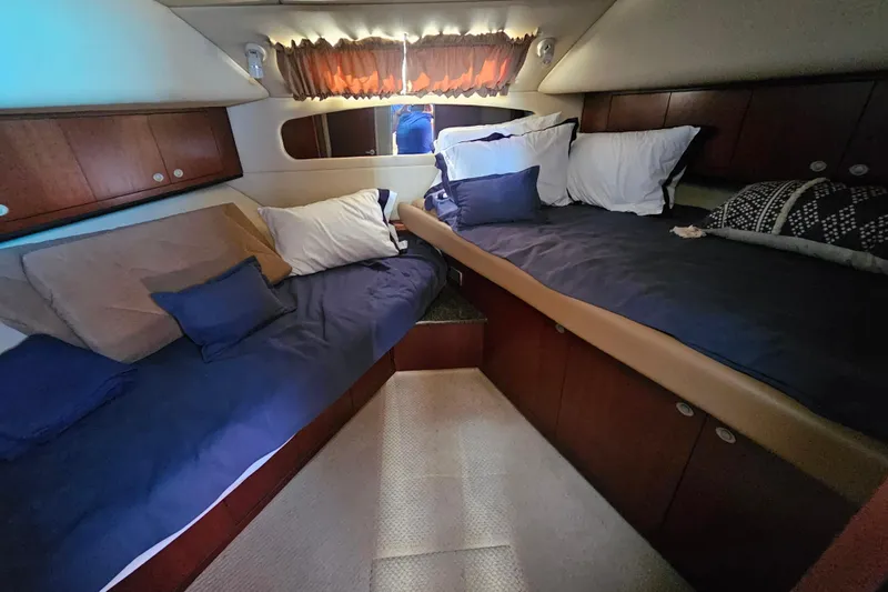Slide: The Image of Luxurious cabin interior of 2005 Sea Ray 390 Motor Yacht with cozy bedding. - 33