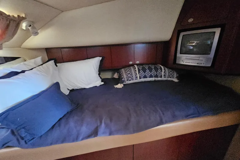 Slide: The Image of 2005 Sea Ray 390 Motor Yacht cabin with cozy bed and TV. - 34