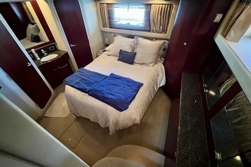 Slide: The Image of Luxurious bedroom interior of 2005 Sea Ray 390 Motor Yacht with cozy bedding and elegant decor. - 37