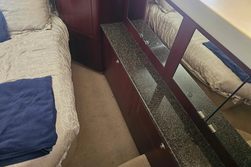 Slide: The Image of Interior of 2005 Sea Ray 390 Motor Yacht with bed and mirrored cabinet. - 38