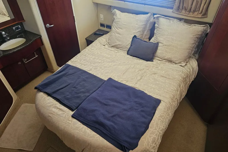 Slide: The Image of Luxurious bedroom interior of 2005 Sea Ray 390 Motor Yacht with elegant bedding. - 39