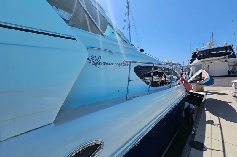 Slide: The Image of 2005 Sea Ray 390 Motor Yacht docked at marina under clear blue sky. - 4