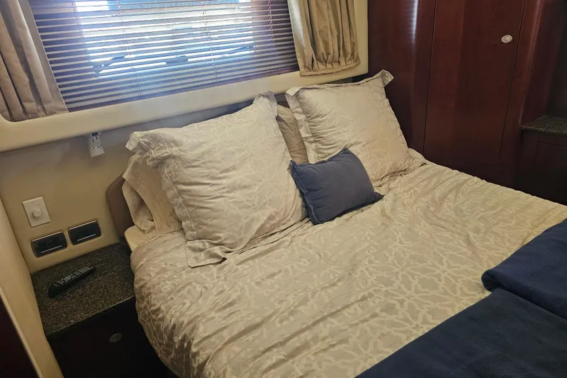 Slide: The Image of Cozy bedroom interior of 2005 Sea Ray 390 Motor Yacht with plush bedding and wooden accents. - 40