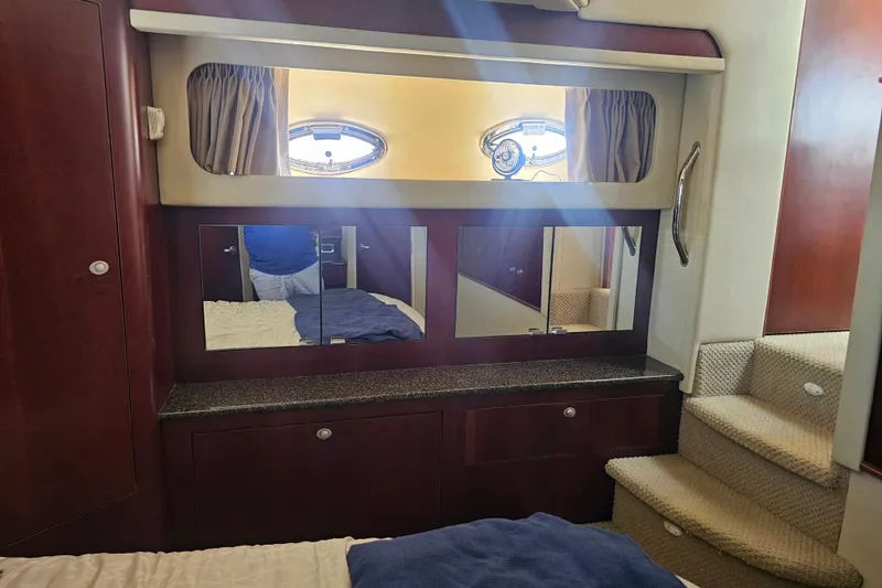 Slide: The Image of Interior of 2005 Sea Ray 390 Motor Yacht with wooden cabinetry and mirrored accents. - 41