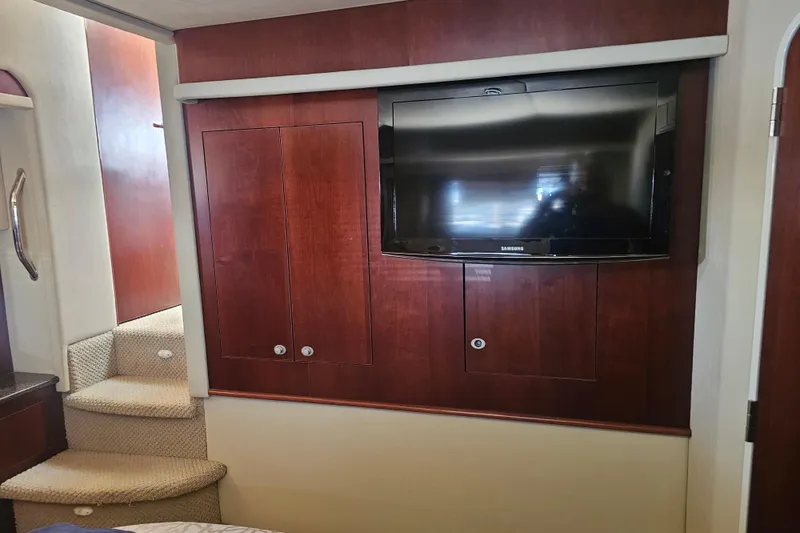 Slide: The Image of Interior of 2005 Sea Ray 390 Motor Yacht with TV and wooden cabinetry. - 42