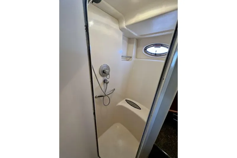 Slide: The Image of Shower area in 2005 Sea Ray 390 Motor Yacht with oval window and chrome fixtures. - 44
